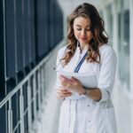 Young woman doctor with stethoscope at hospital