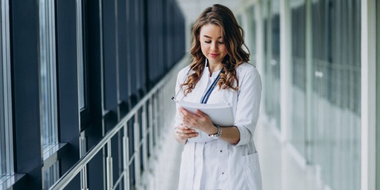 Young woman doctor with stethoscope at hospital