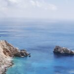 Vertical shot of Agia Anna in Amorgos Island, Greece under a blue sky