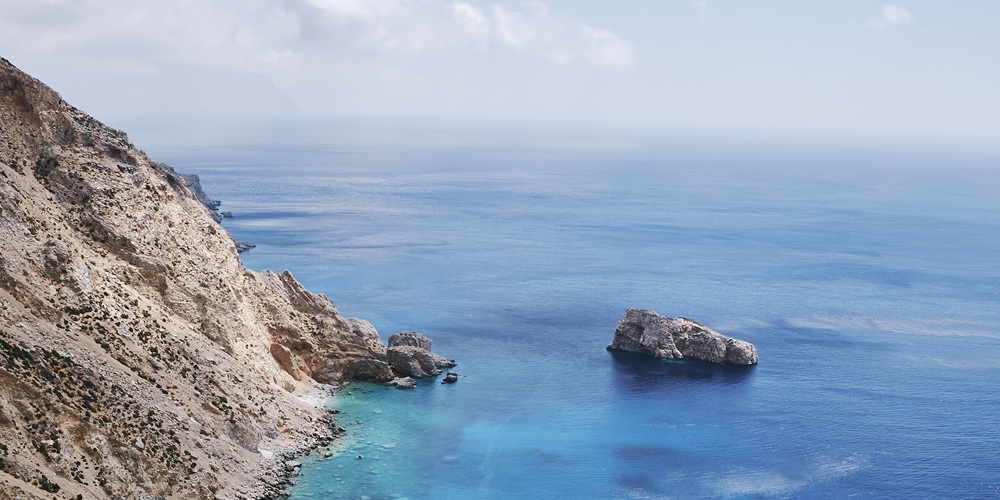 Vertical shot of Agia Anna in Amorgos Island, Greece under a blue sky Vertical shot of Agia Anna in Amorgos Island, Greece under a blue sky