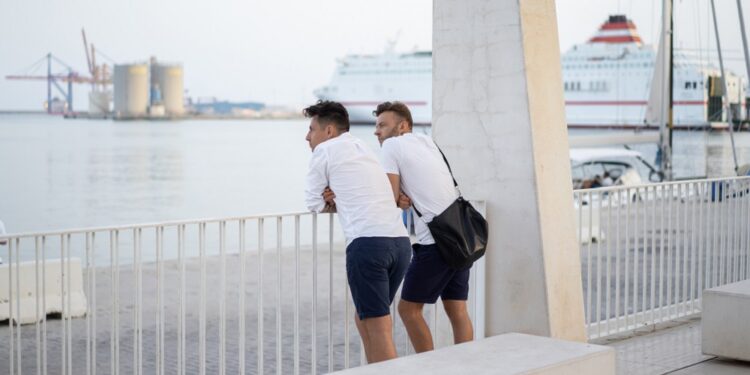 two men of a friend on the city promenade in Malaga