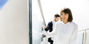 Wife and husband going up on stairs in sky